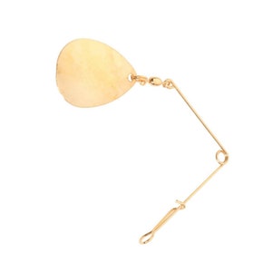 May include: A gold-colored fishing lure with a teardrop-shaped blade and a wire arm. The blade is connected to a swivel and the wire arm has a loop at the end. The lure is designed to attract fish.