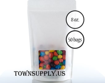 May include: White stand-up pouch with a clear window showing colorful candy. The pouch is labeled "8 oz." and "50 bags". The text "TOWN SUPPLY.US" is printed on the bottom of the pouch.