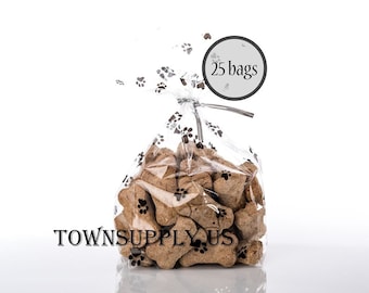 May include: A clear plastic bag with a paw print design filled with dog bone-shaped treats. The bag has a silver twist tie and a white circle label that says "25 bags".