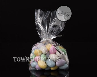 May include: Fifty clear cellophane bags with twist ties, filled with pastel colored candy almonds.  The bags are perfect for party favors or small gifts.
