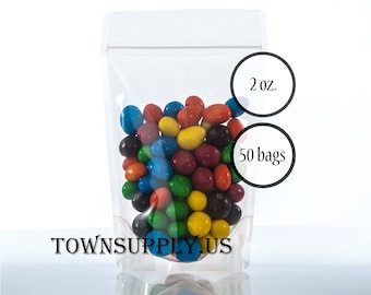May include: A clear plastic stand-up pouch with a zipper closure filled with colorful candy. The pouch is labeled "2 oz." and "50 bags".