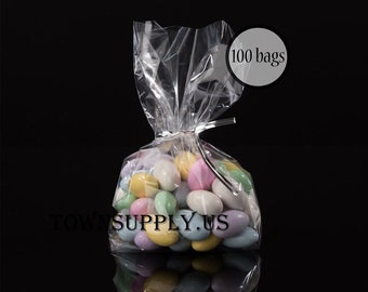 May include: A clear plastic bag filled with pastel-colored candy. The bag is tied with a silver twist tie. The bag is labeled "100 bags".