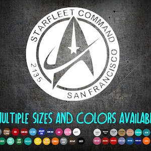 May include: White Starfleet Command logo with the text "STARFLEET COMMAND SAN FRANCISCO 2135" on a dark gray background. The text "MULTIPLE SIZES AND COLORS AVAILABLE" is below the logo, with a color palette.