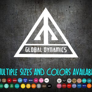 May include: White logo with the text "GLOBAL DYNAMICS" inside a triangle on a textured gray background. The text "MULTIPLE SIZES AND COLORS AVAILABLE" is below the logo, with a color palette at the bottom.