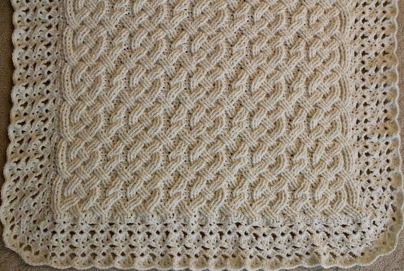 Quote from creator's blog post: A pretty braided cable dishcloth