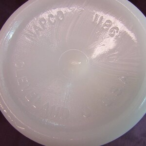 May include: White milk glass pitcher with a textured surface and the words "WACO 1966" embossed on the bottom.