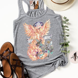 May include: Gray tank top with a phoenix illustration in shades of orange, yellow, and red. The phoenix is surrounded by flowers and the text "My Fire, My Light".
