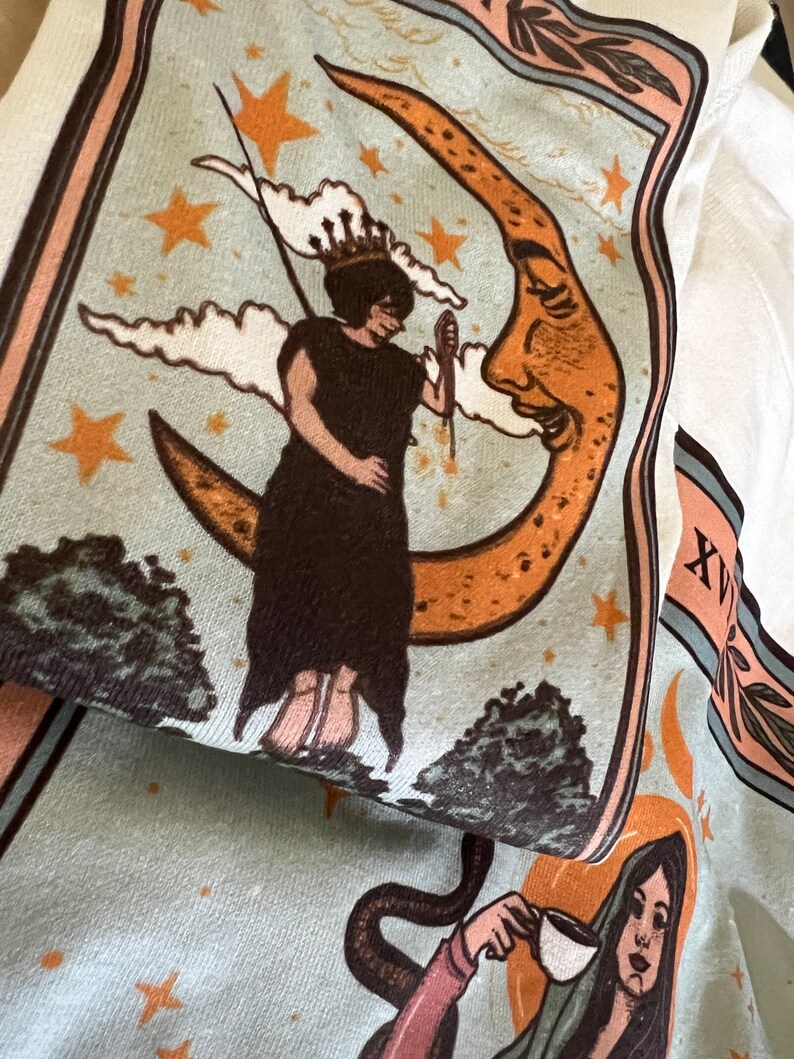 May include: A vintage-style illustration of a woman standing on a crescent moon with a face. The moon is orange and yellow with brown spots. The woman is wearing a long brown dress and a crown. The background is blue with white clouds and gold stars.