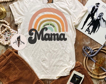 May include: A white t-shirt with a rainbow design and the text "Special Needs Mama" in a retro font.