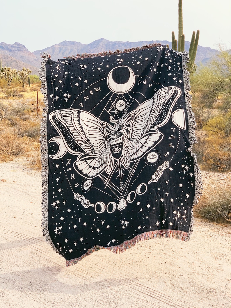 May include: Black woven tapestry with a white moth design, crescent moons, stars, and other celestial symbols.