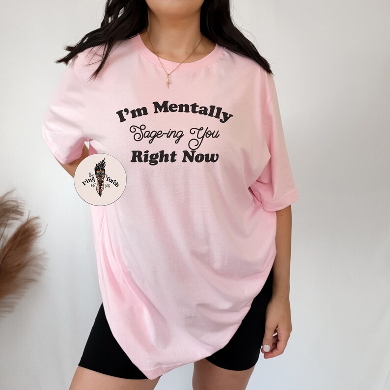 May include: Pink oversized t-shirt with the text "I'm Mentally Sage-ing You Right Now" printed in black.