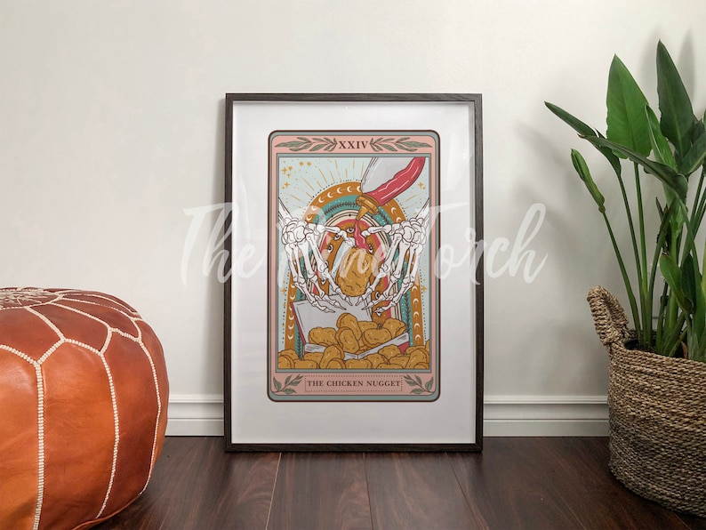May include: A tarot card illustration with a skeletal hand holding a chicken nugget. The card is titled "The Chicken Nugget" and is framed in a black frame.