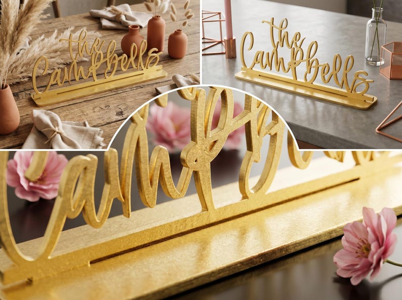 May include: A gold-colored wooden sign that reads "the Campbells" in a cursive font. The sign is displayed on a table, with a slot to hold place cards. The sign is a decorative item.