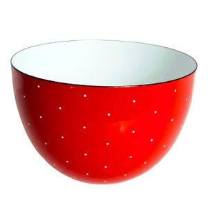 May include: A red enamel bowl with white polka dots. The bowl is round and has a white interior.