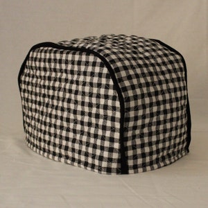 May include: Black and white checkered quilted toaster cover with a black trim.