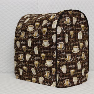 May include: Brown and white kitchen appliance cover with a coffee theme. The cover is decorated with a repeating pattern of coffee cups, coffee beans, and the words "Coffee", "Java", "Latte", "Espresso", and "Cappuccino".