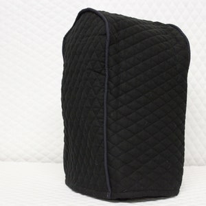 May include: Black quilted cover for a kitchen appliance. The cover has a diamond pattern and a dark blue trim.