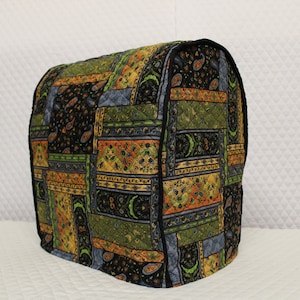 May include: A quilted food processor cover with a black, green, blue, and orange paisley pattern.