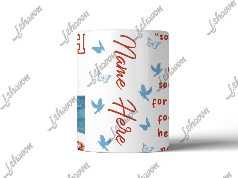 May include: White ceramic mug with a wraparound design featuring blue butterflies and birds. The mug has the words "Name Here" in red script, along with other text. A small image is visible on the side.