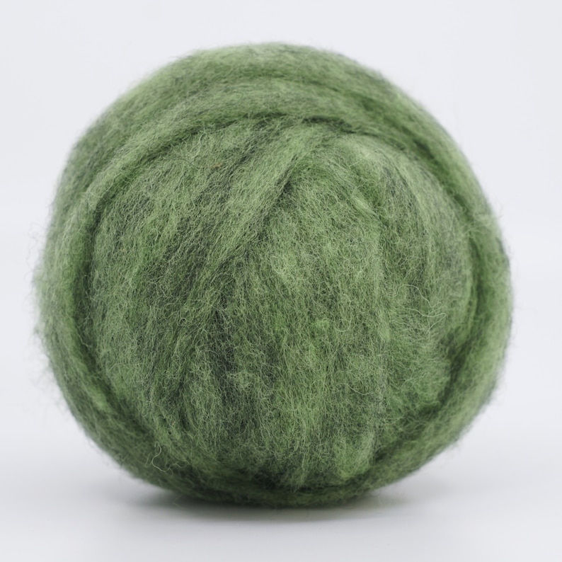 May include: A ball of green wool yarn. The yarn is soft and fluffy, and it is perfect for knitting or crocheting.
