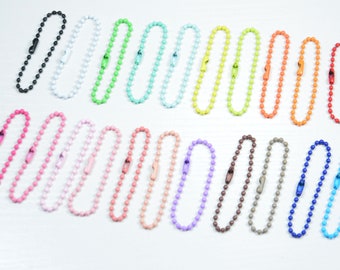 May include: Assortment of 20 colourful ball chain keychains. The chains are made of metal and come in a variety of colours, including black, white, green, blue, yellow, orange, red, pink, purple, brown, grey, and turquoise.