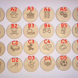 May include: Twenty-four wooden circles with different designs and letters A1 through D6. The circles are arranged in four rows of six circles each.