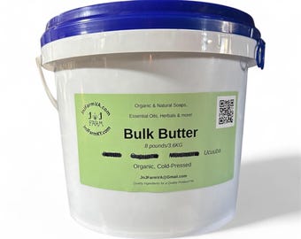 May include: A white plastic bucket with a blue lid, labelled "Bulk Butter." The label states the butter weighs 3.6 kg (8 pounds) and is organic and cold-pressed. Additional text includes "Organic & Natural Soaps, Essential Oils, Herbals & more!"