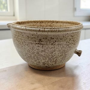 May include: A rustic wooden sign with the text "Welcome to our home" in white lettering. The sign features a distressed finish and a simple, inviting design, perfect for front door decor.