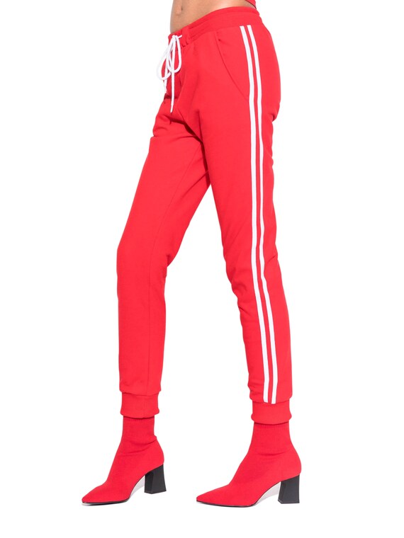 black tracksuit bottoms with red stripe