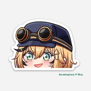 May include: A cartoon illustration of a girl with blonde hair wearing a blue cap with goggles. She is smiling and looking at the viewer. The image is in a sticker format.
