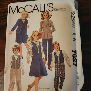 May include: A vintage McCall's sewing pattern packet featuring illustrations of children's clothing. The packet shows various outfits, including blazers, vests, and pants. The price is $2.25, and the size is 14.
