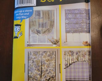 May include: A sewing pattern for window shades, labelled "Sewing Pattern for Dummies." The pattern shows four different shade designs. The package is yellow with the Simplicity and Wrights logos. The text "Stitch up a storm the Fun and Easy Way" is also visible.