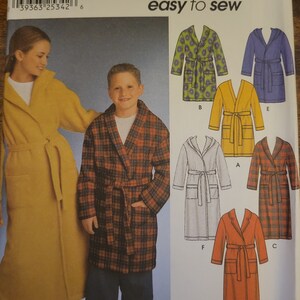 May include: Simplicity sewing pattern number 9941 for sizes 12, 14, and 16. The pattern includes instructions for making six different robes, including a plaid robe, a solid yellow robe, a floral robe, a solid blue robe, a solid white robe, and a solid red robe. The pattern is designed by Karen Z.