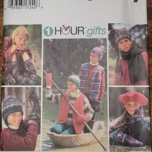 May include: A Simplicity sewing pattern booklet with the title "1 HOUR gifts" and images of children wearing various winter accessories, including hats, scarves, and mittens.