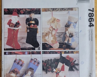 May include: A sewing pattern for making Christmas stockings. The pattern includes instructions for making stockings with a variety of designs, including Santa Claus, a snowman, and an angel. The pattern is from McCall's Crafts and is numbered 7864.
