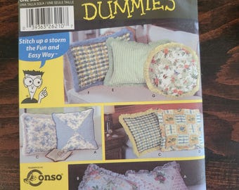 May include: A sewing pattern packet titled "Sewing Patterns for Dummies" with images of various decorative cushions. The packet features the brand names "Simplicity", "Conso", and "Wrights". The text "Stitch up a storm the Fun and Easy Way" is also visible.