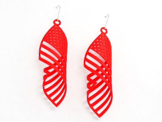 Premium Photo | A pair of american flag earrings with a white, red and blue american  flag design.