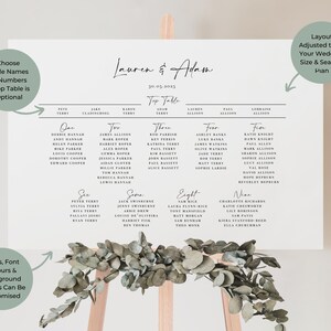 a wedding seating chart with eucalyptus leaves on a wooden easel