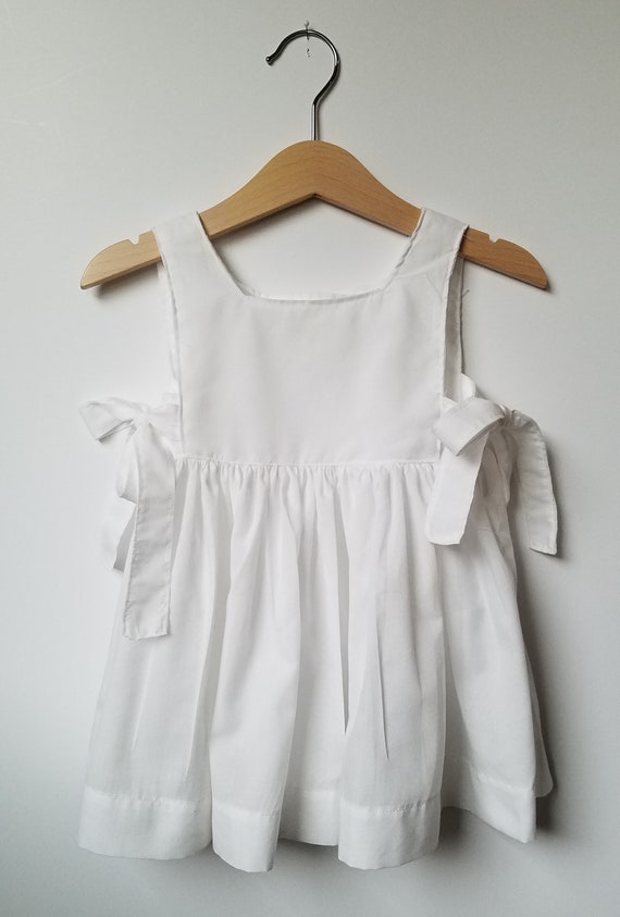 white pinafore dress