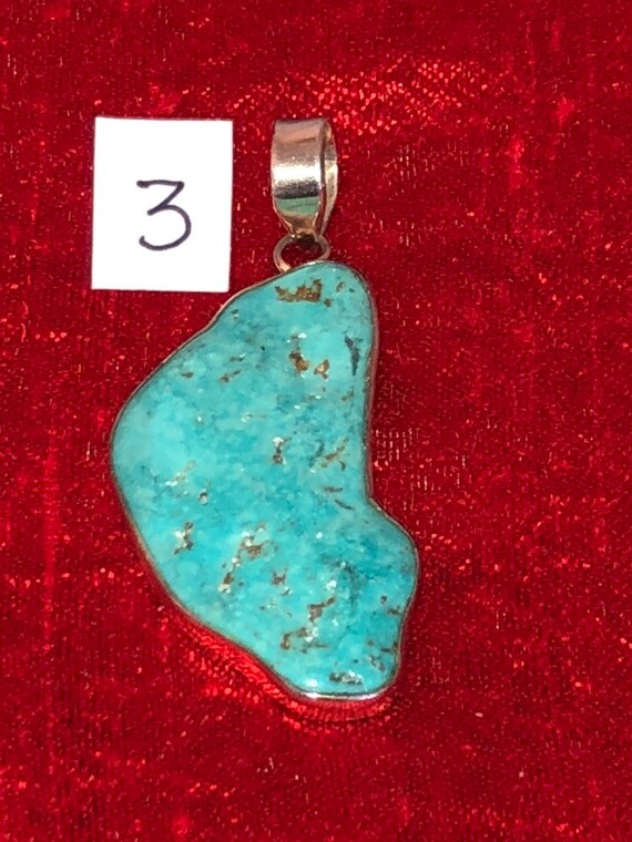 One handmade sterling silver and turquoise pendant