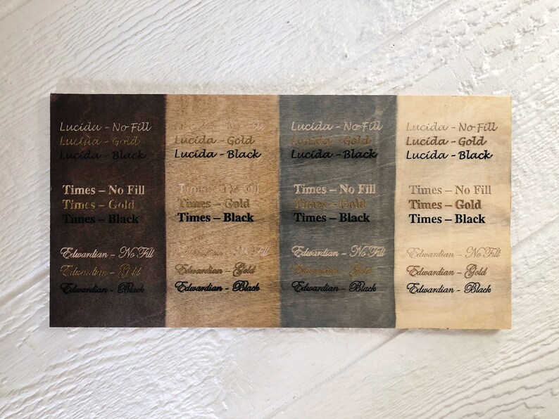 May include: Four wood samples with different wood stains and text showing the font names "Lucida", "Times", and "Edwardian" in different styles: no fill, gold, and black.