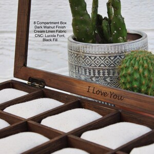 May include: A wooden box with eight compartments, lined with white fabric. The box has a dark walnut finish and is engraved with the words "I Love You".