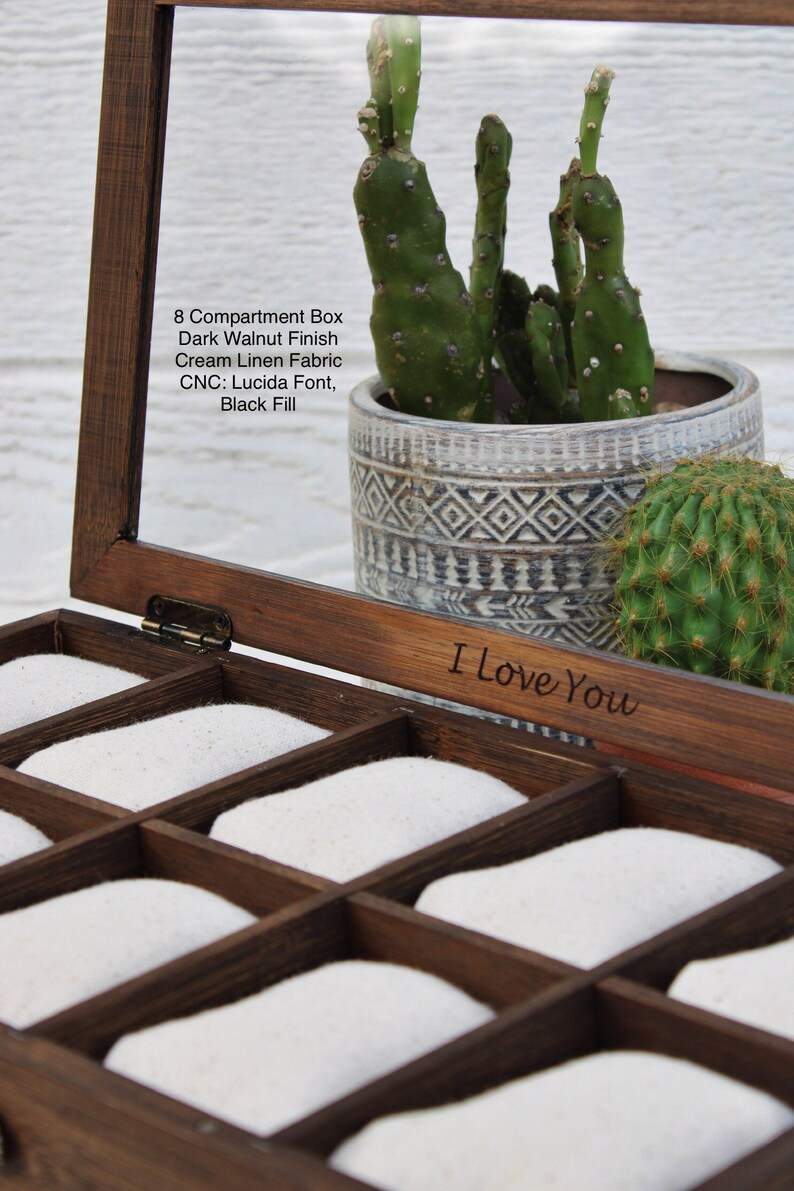 May include: A wooden box with eight compartments, lined with white fabric. The box has a dark walnut finish and is engraved with the words "I Love You".