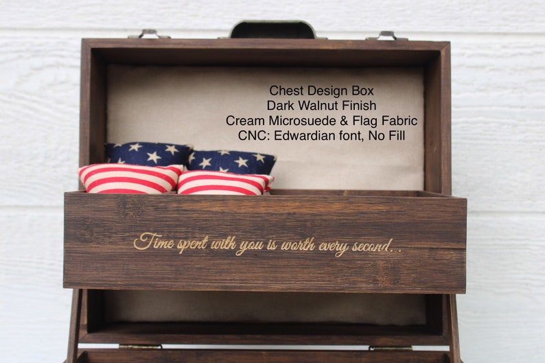 May include: A wooden chest with a dark walnut finish, lined with cream microsuede and flag fabric. The chest is engraved with the text "Chest Design Box", "Dark Walnut Finish", "Cream Microsuede & Flag Fabric", "CNC: Edwardian font, No Fill", and "Time spent with you is worth every second."