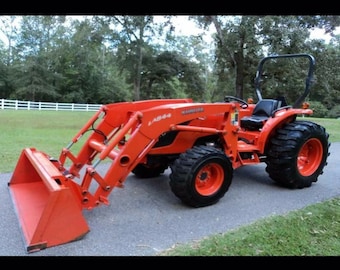 May include: A red Kubota L484 tractor with a front loader and a bucket. The tractor has a black roll bar and a black seat. The tractor is on a paved driveway.
