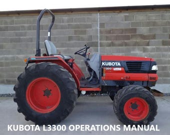 May include: A red Kubota L3300 tractor with a black roll bar and a gray hood. The tractor has large black tires and a black grill. The tractor is parked in front of a gray brick wall.