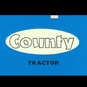 May include: A blue and white logo for County Tractor. The logo features the word "County" in a white oval with a black outline. The word "TRACTOR" is written in black below the oval.