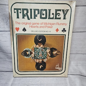 May include: A rectangular Tripoley board game box, Deluxe Edition No. 111. The white cover features the title in large dark green letters, red text describing the game, and four card suit symbols. A central image shows four people playing.