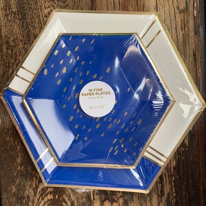 May include: A package of 18 fine paper plates in a blue and white hexagonal design with gold accents. The plates are 7.5 inches in diameter and feature a gold confetti pattern.