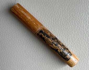 May include: A wooden tube with a black and white image of a building and text printed on it. The tube is about 10 inches long and has a diameter of about 1 inch.